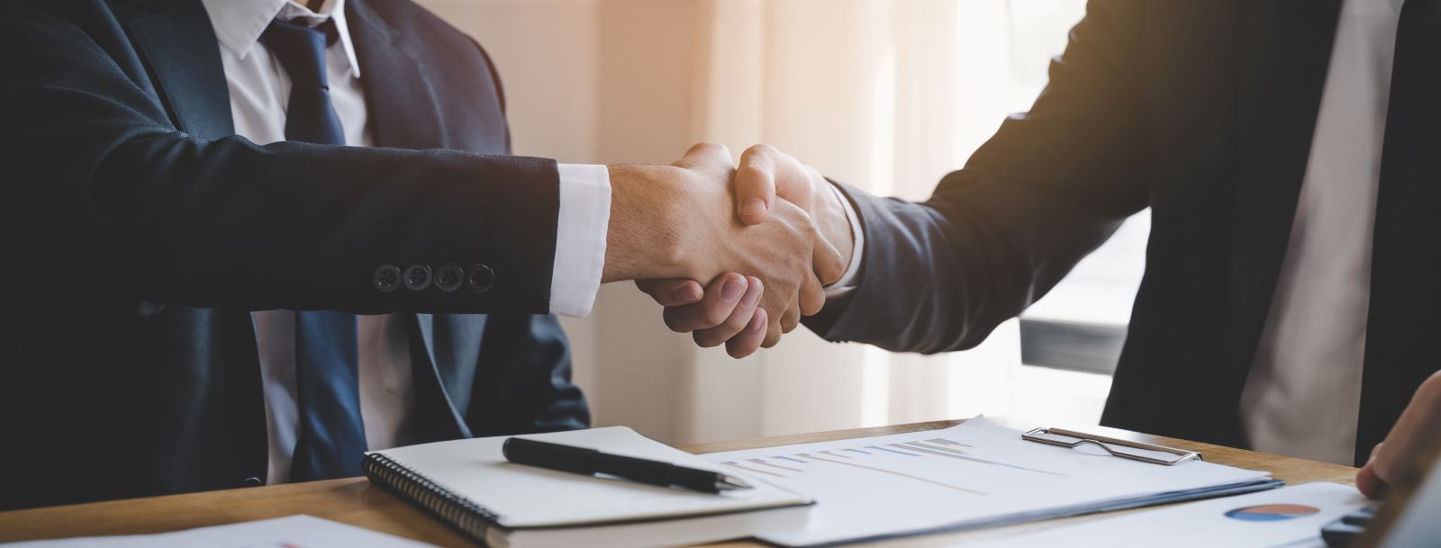 men shaking hands in suits