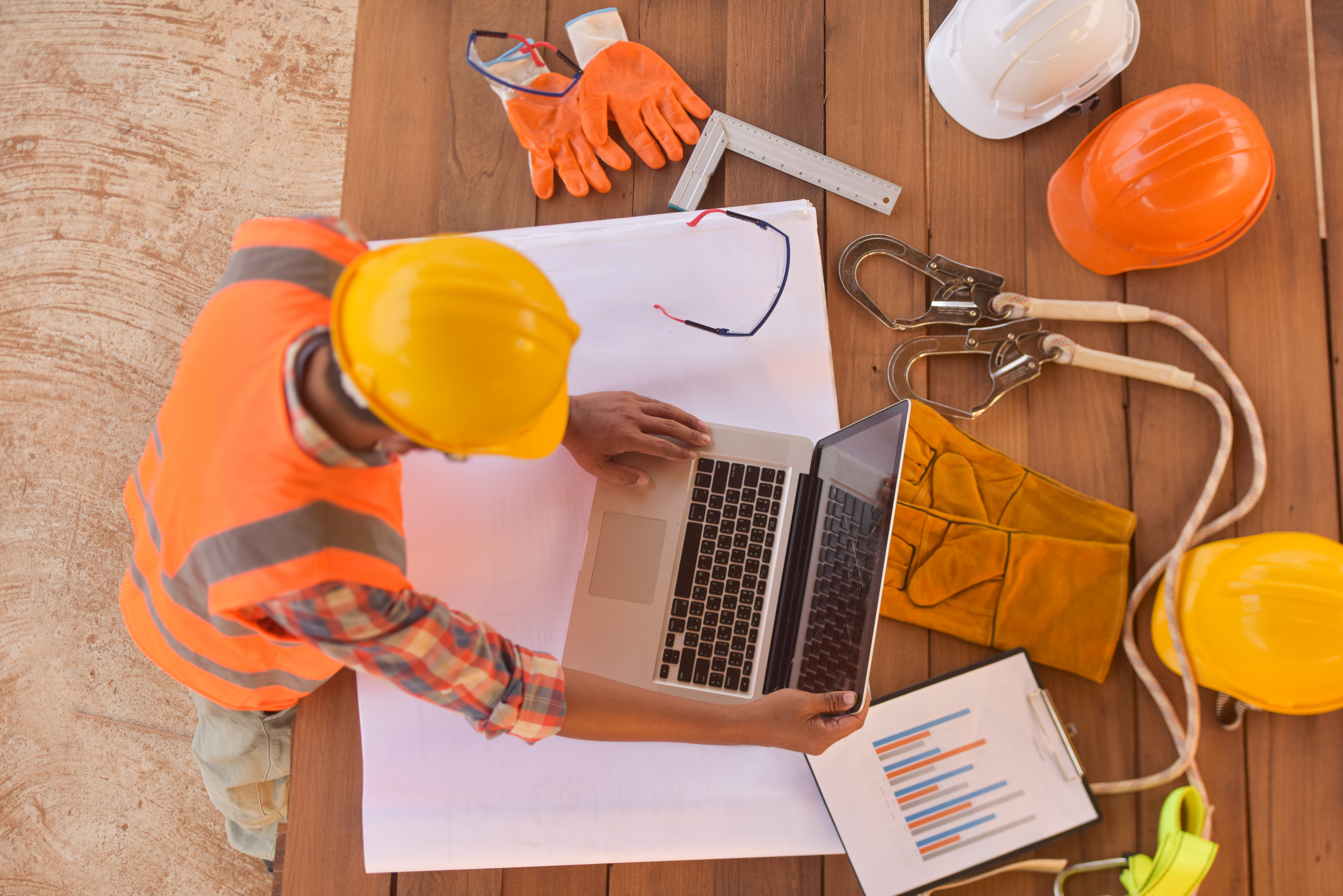 construction in orange vest on a table